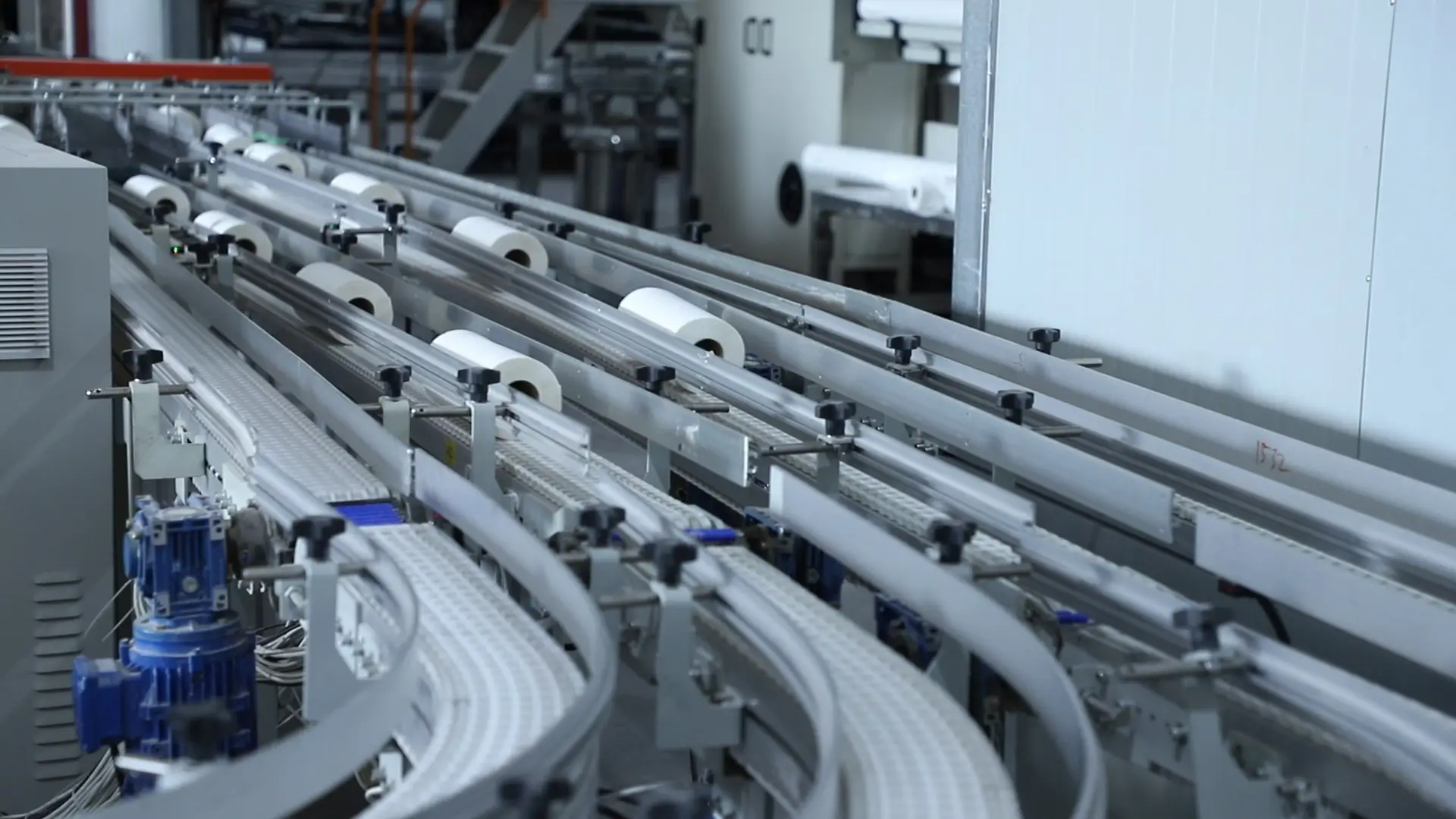 Parent jumbo rolls being rewound and cut into smaller rolls in step 7 of the bamboo tissue manufacturing process